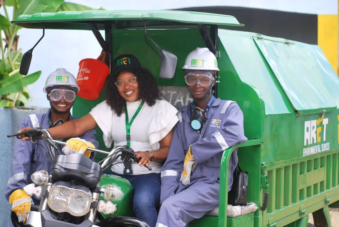 ARET field team members with a branded waste collection vehicle