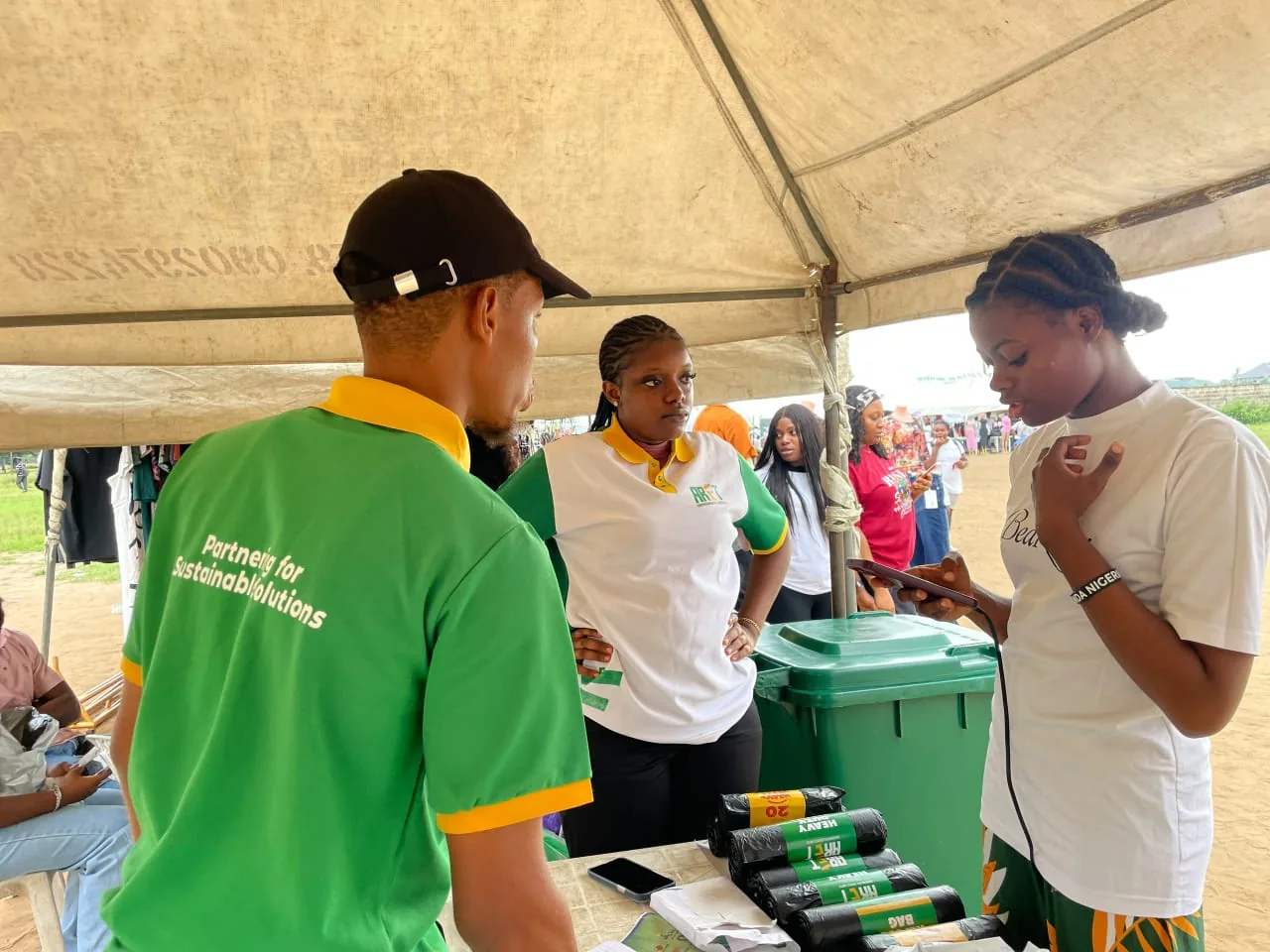 ARET team speaking with a visitor at an environmental services stand